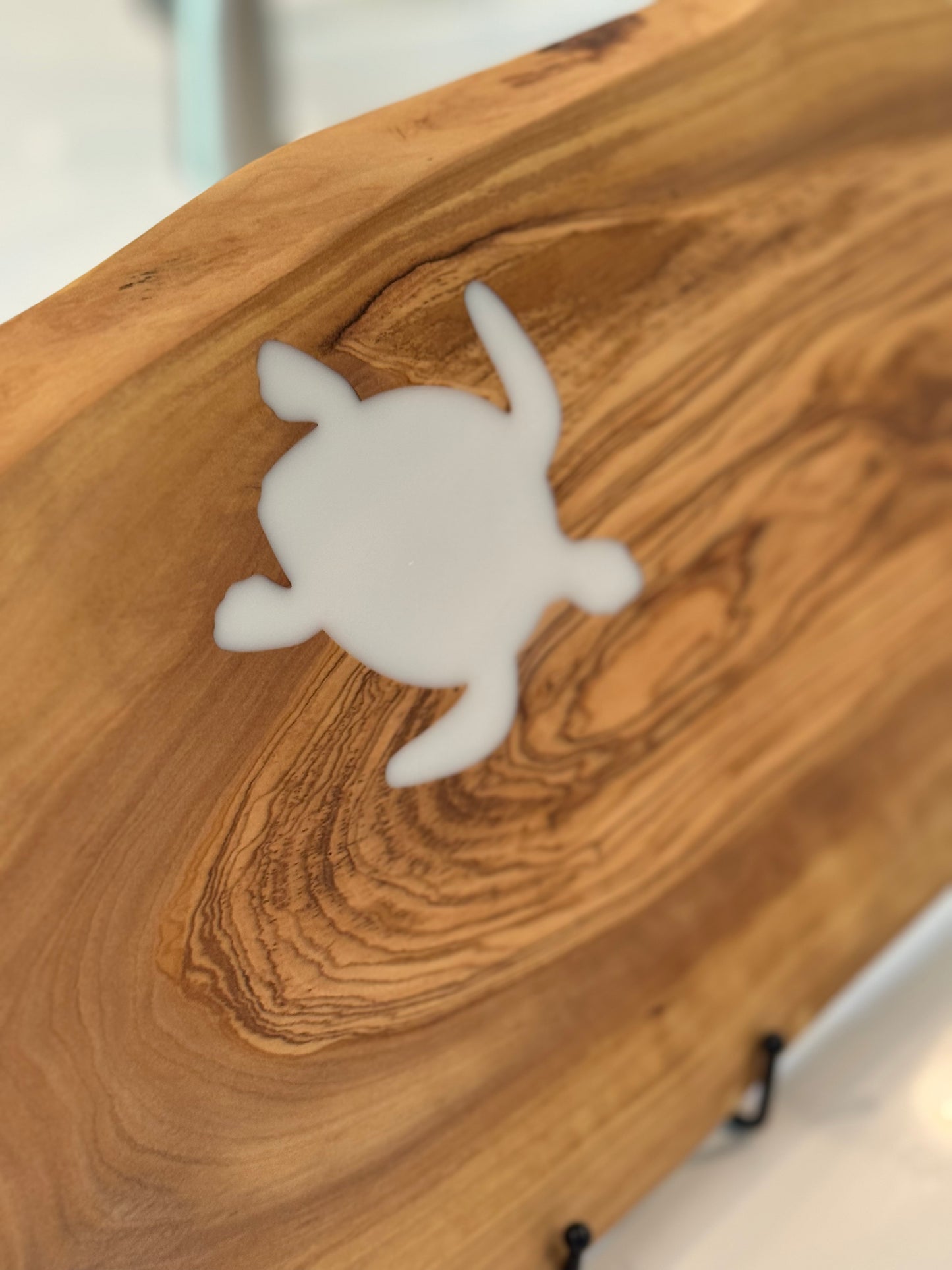White turtle-shaped object on a wooden surface